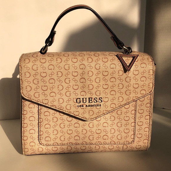 pink guess purse with charms